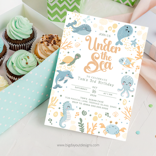 Under the Sea birthday party invitation with cupcakes on a light surface