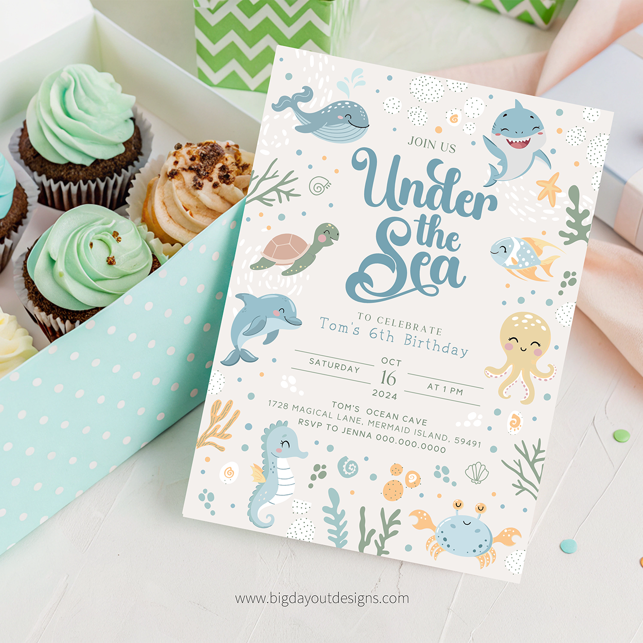 Under the Sea birthday party invitation with cupcakes on a white surface