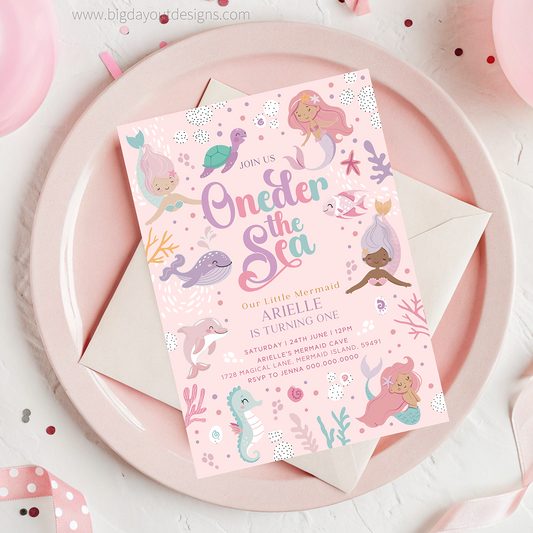 Under the sea themed birthday invitation on a pink plate with mermaid illustrations.