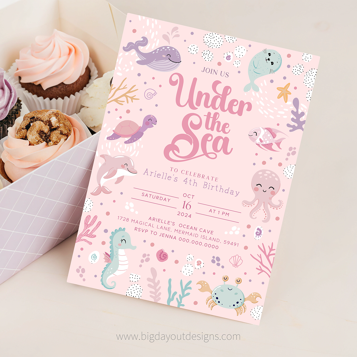 Under the Sea birthday invitation with sea creature illustrations on a pink background, surrounded by cupcakes.