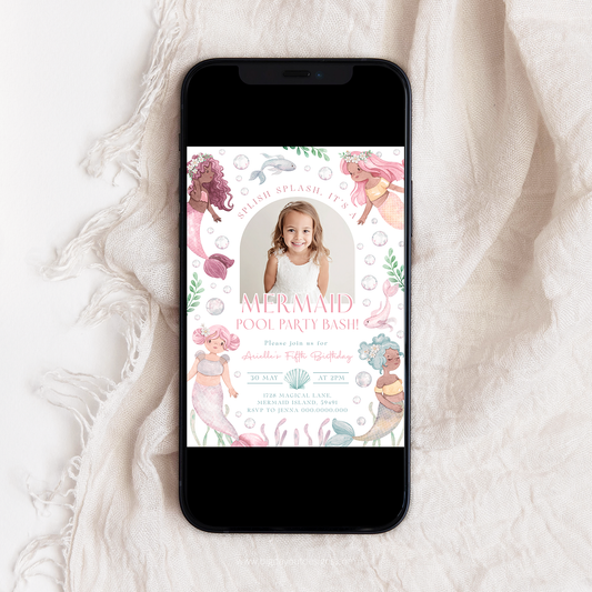 Phone displaying a mermaid-themed birthday party invitation on a white fabric background