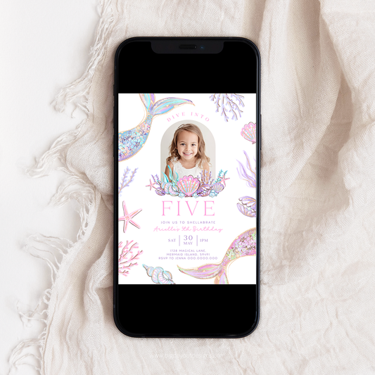 Phone displaying a birthday invitation with mermaid design on a textured white surface