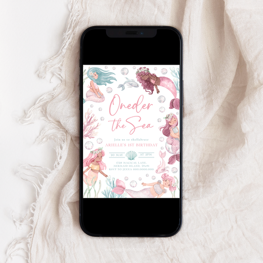 Phone displaying a mermaid-themed birthday invitation on a textured white surface