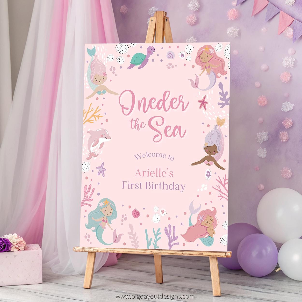 Birthday party sign with mermaid theme on an easel against a decorative background.
