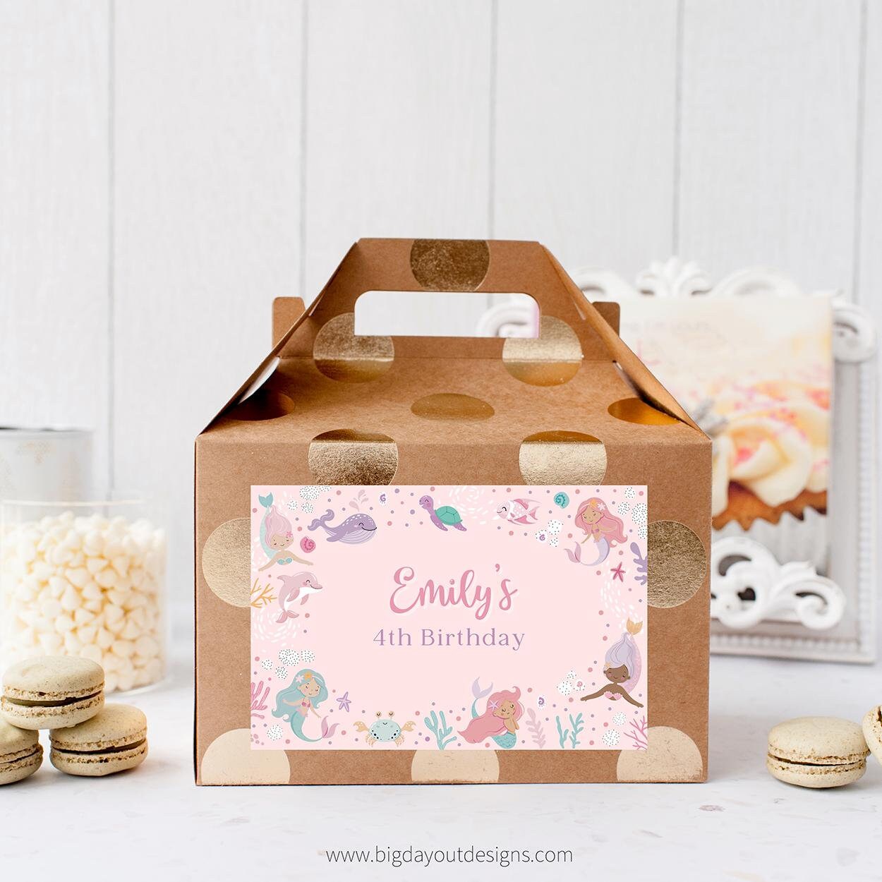 Gift box with a personalized mermaid-themed label on a white surface