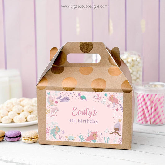 Gift box with a personalized label for a birthday party, featuring mermaid designs and the name 'Emily'.