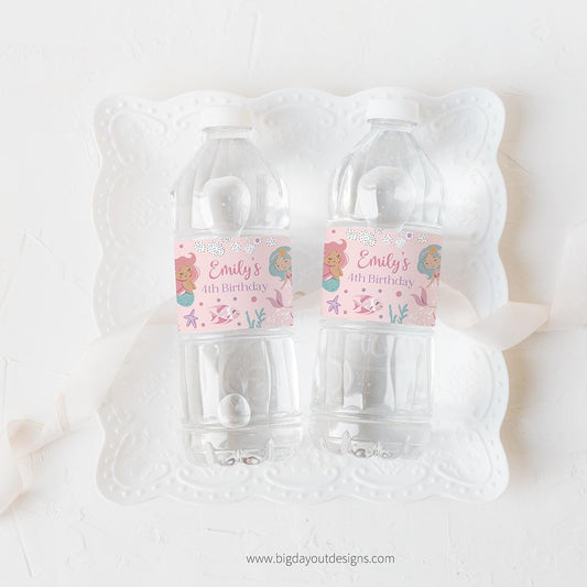 Two clear water bottles with personalized labels on a white background