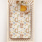Crib with a floral dog and cat patterned crib sheets