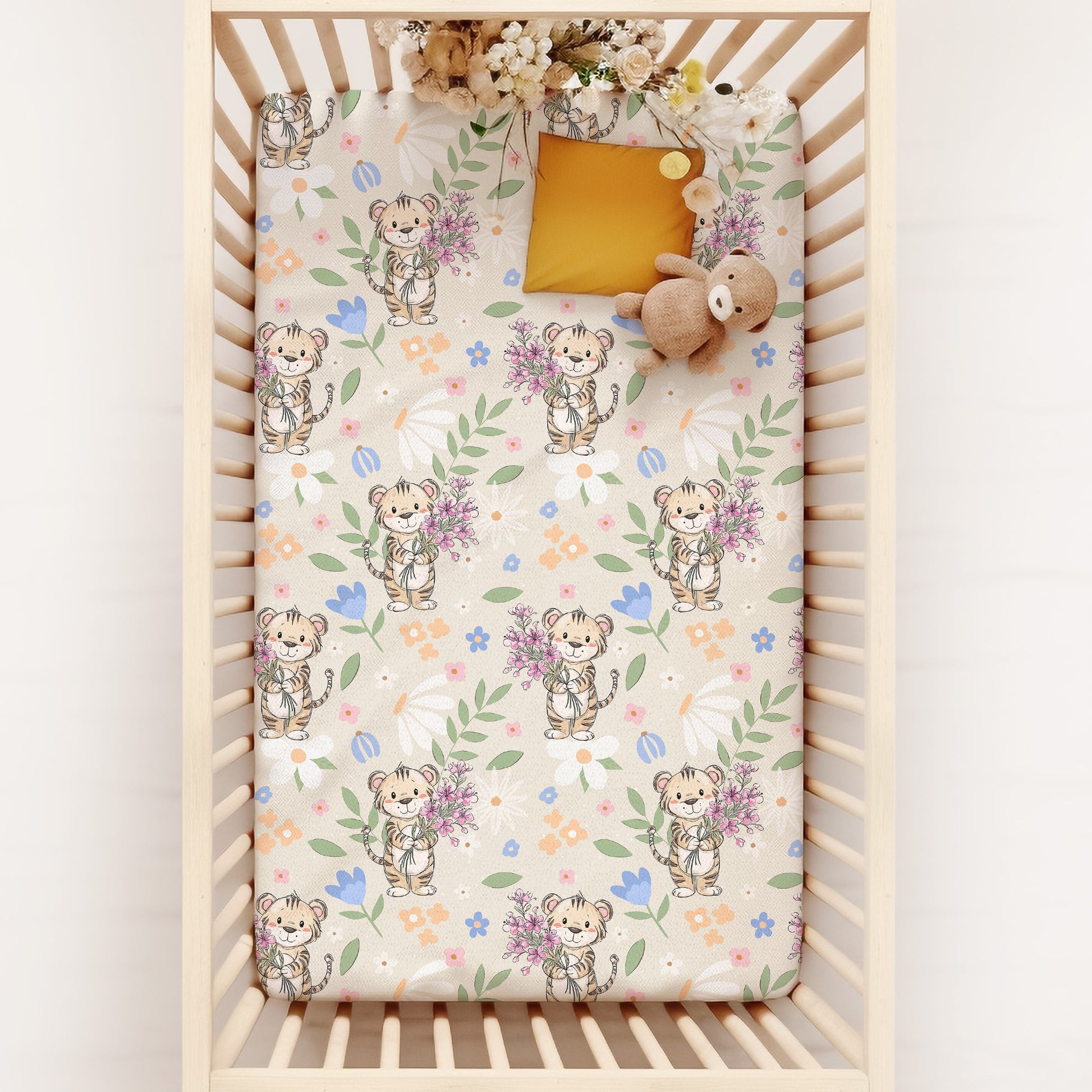 Crib with a floral and baby tiger patterned sheet