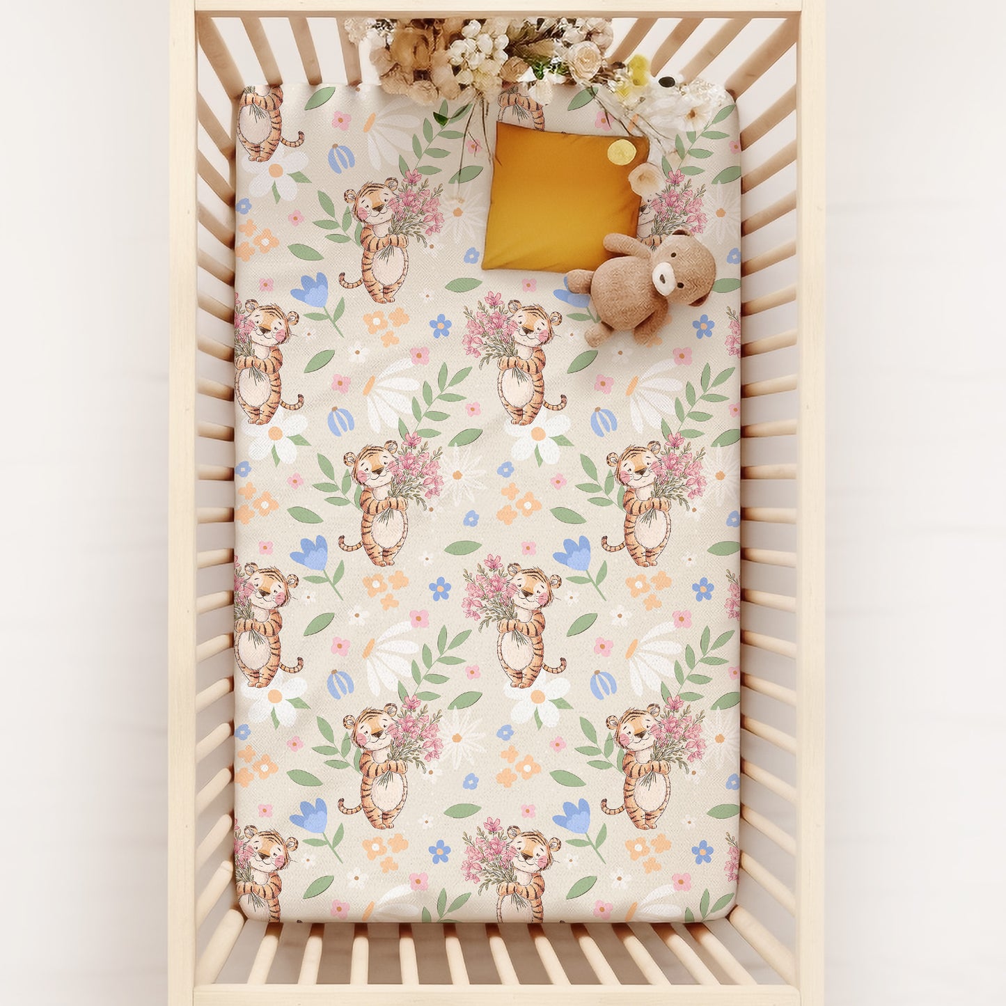 Crib with a floral and tiger patterned sheet