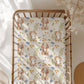 Crib sheet with puppy and kitten pattern on a wooden crib