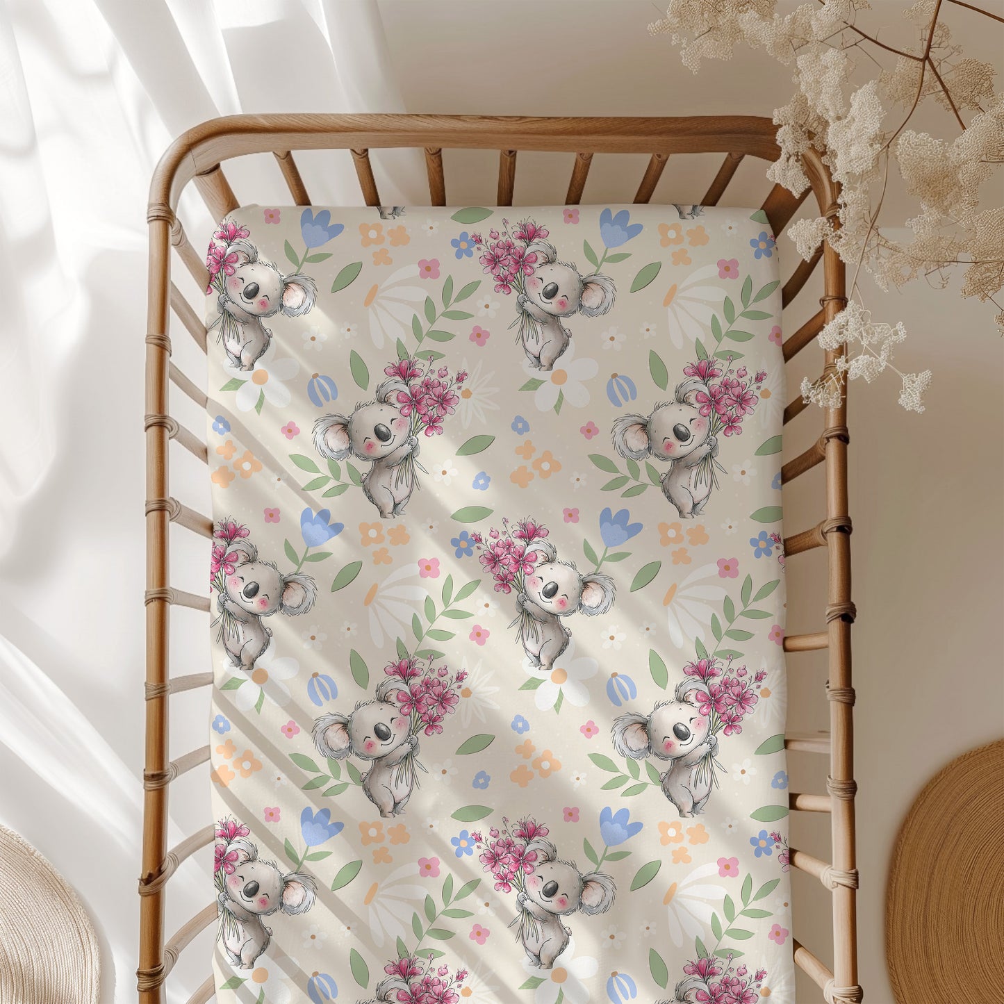 Crib sheet with koala and floral pattern on a wooden crib