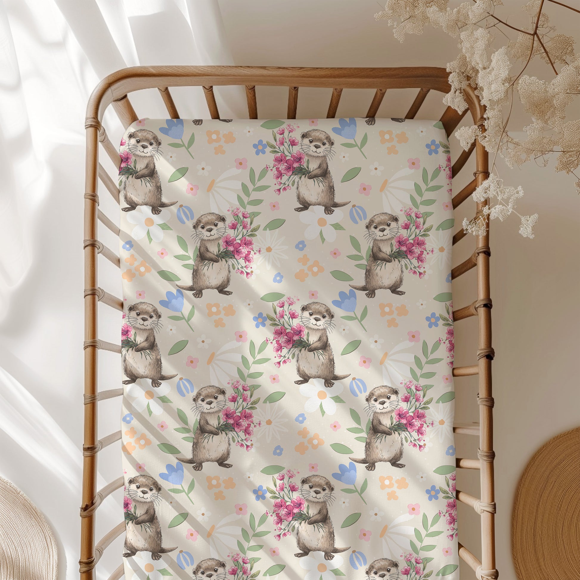 Floral patterned blanket with otter illustrations on a wooden crib
