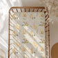 Crib with a classic Winnie the Pooh patterned sheet in a bright room.