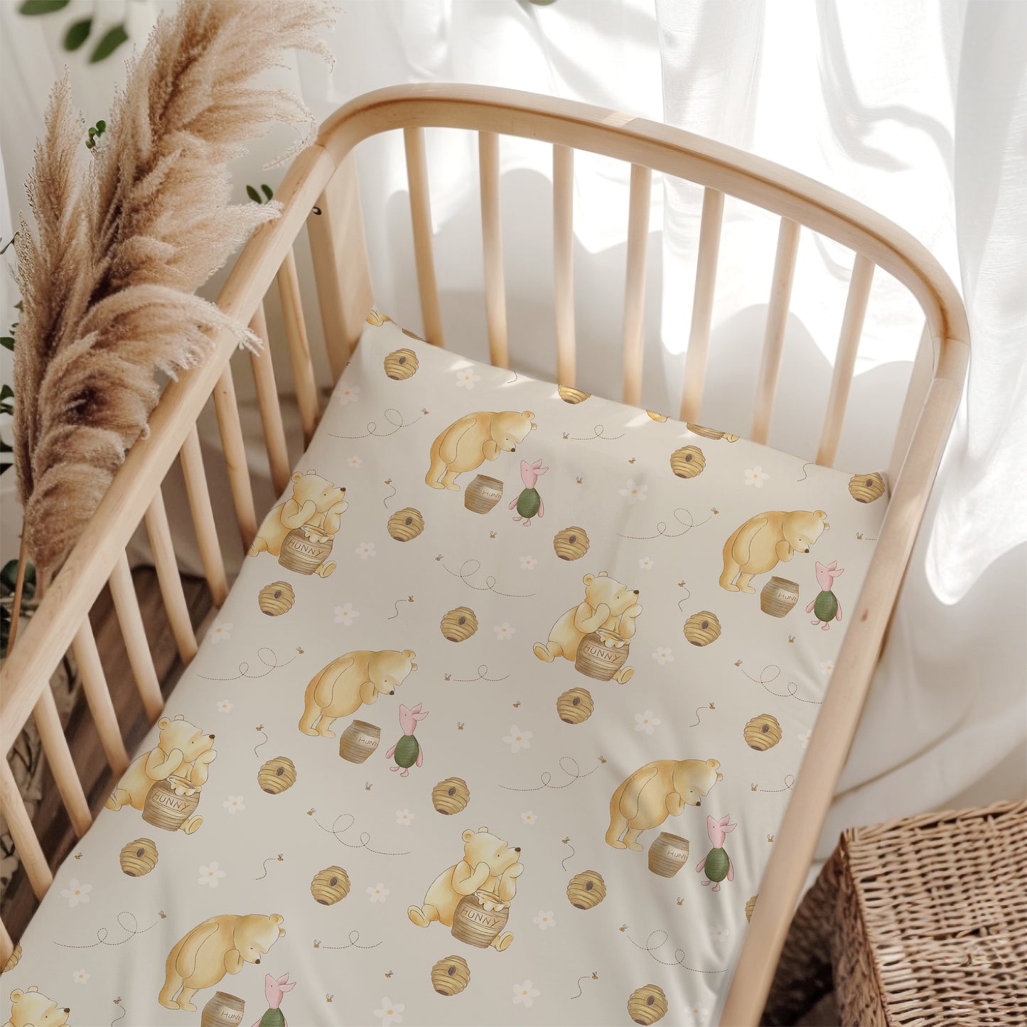 Crib with a patterned sheet featuring classic winnie the pooh in a cozy room.