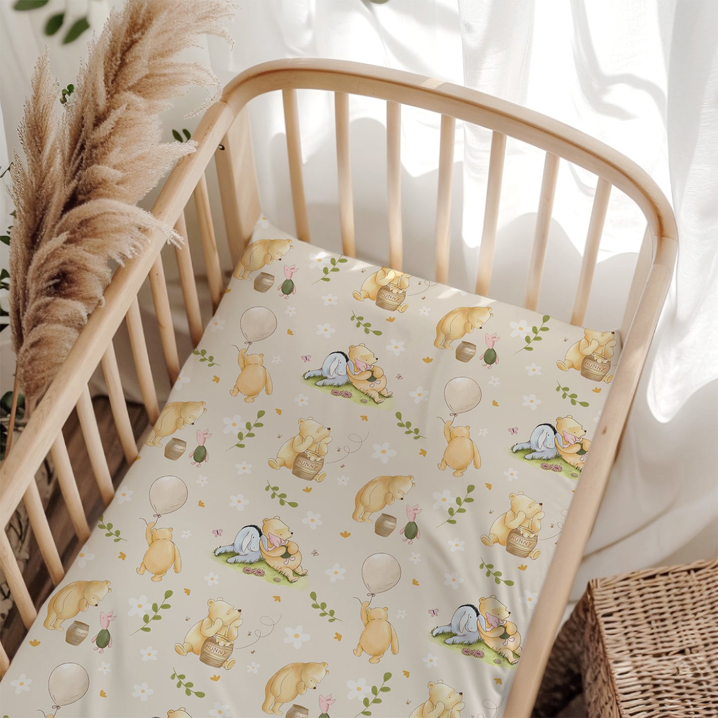 Crib with a Winnie the Pooh patterned sheet in a softly lit room.