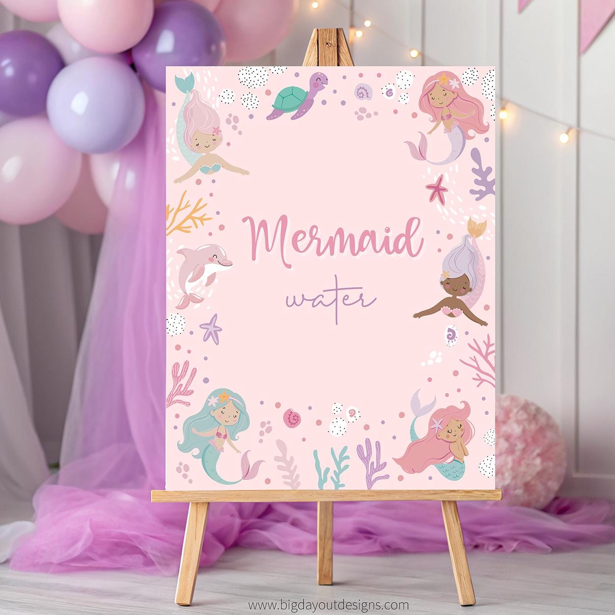 Mermaid-themed poster on an easel with balloons and decorations in the background