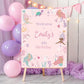 Birthday party sign with mermaid design and balloons in the background